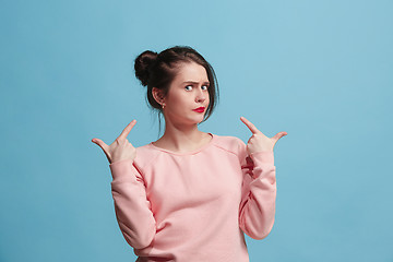 Image showing Beautiful woman looking suprised and bewildered isolated on blue