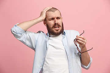 Image showing Man having headache. Isolated over pink background.