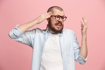 Image showing Man having headache. Isolated over pink background.