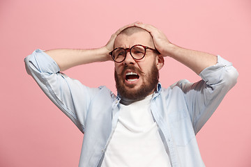 Image showing Man having headache. Isolated over pink background.