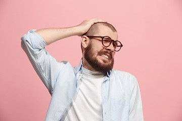 Image showing Man having headache. Isolated over pink background.