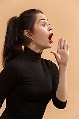 Image showing Isolated on pastel young casual woman shouting at studio