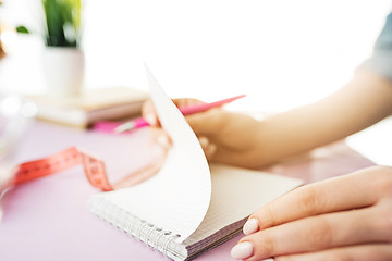 Image showing The business woman in the workplace flips through the dailybook