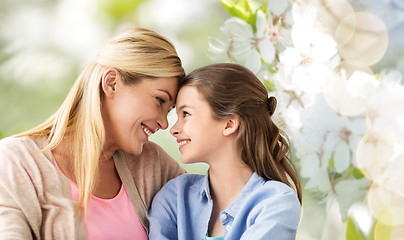 Image showing happy mother and daughter over cherry blossom