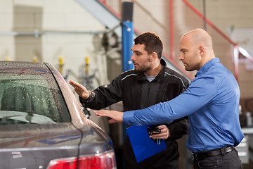 Image showing auto mechanic and customer at car shop