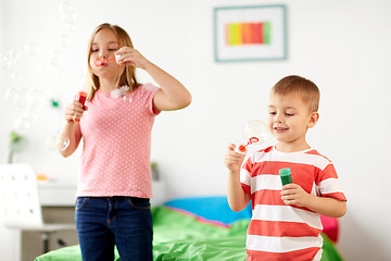 Image showing kids blowing soap bubbles and playing at home