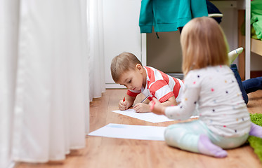 Image showing happy kids drawing at home