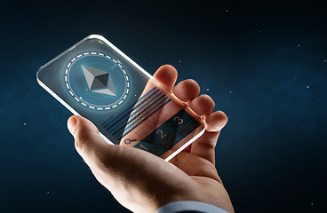 Image showing male hand with ethereum on smartphone screen