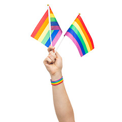 Image showing hand with gay pride rainbow flags and wristband