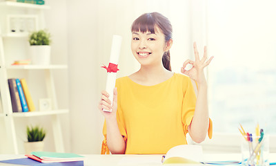 Image showing happy asian woman student with diploma at home