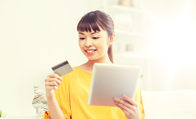 Image showing happy asian woman with tablet pc and credit card