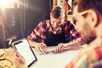 Image showing workmen with tablet pc and blueprint at workshop