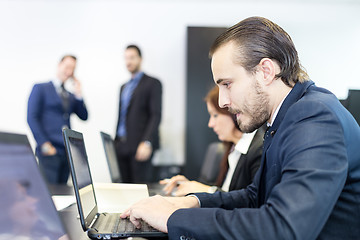 Image showing Business people in modern corporate office.