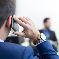 Image showing Corporate business team at business meeting and manager talking on phone.