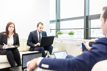 Image showing Business people sitting at working meeting in modern corporate office.