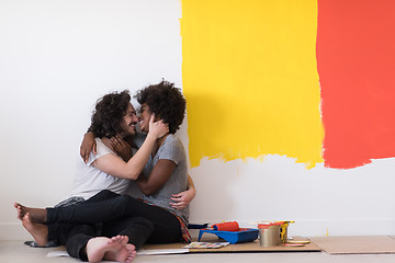 Image showing young multiethnic couple relaxing after painting