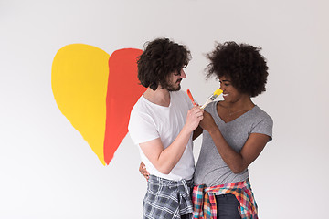 Image showing couple with painted heart on wall