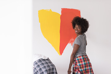 Image showing multiethnic couple painting interior wall