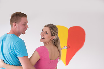 Image showing couple are painting a heart on the wall