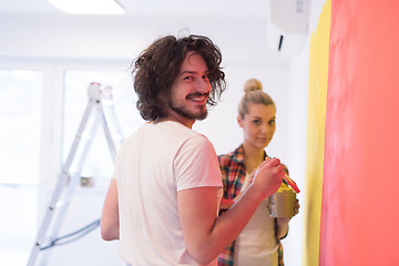 Image showing couple painting interior wall