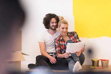 Image showing Happy young couple relaxing after painting