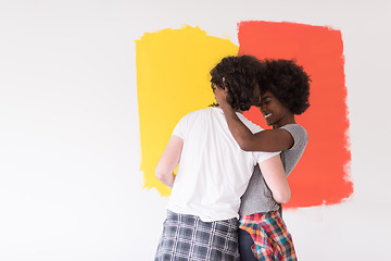 Image showing multiethnic couple painting interior wall