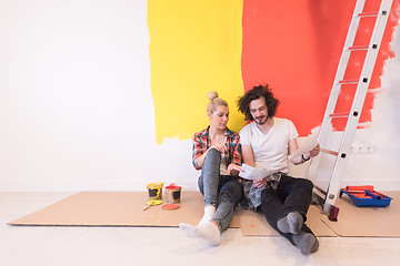 Image showing Happy young couple relaxing after painting