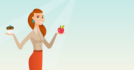 Image showing Woman choosing between apple and cupcake.