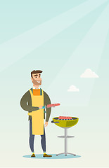 Image showing Man cooking steak on barbecue grill.