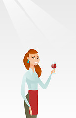 Image showing Waitress holding a glass of wine in hand.