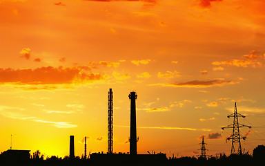 Image showing Industrial landscape with silhouettes of pipes and towers agains