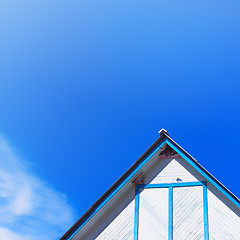 Image showing Top Of A Rustic Wooden Building With A Gable Roof Against The Sk