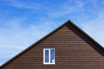 Image showing Top Of A Wooden Plank House Against The Sky