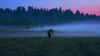 Image showing Photographer With A Tripod Shooting The Fog At Dusk