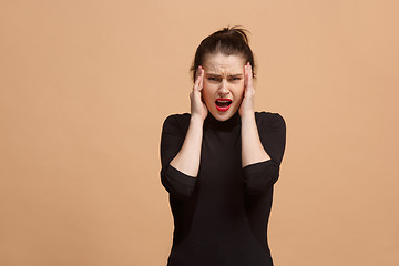 Image showing Woman having headache. Isolated over pastel background.