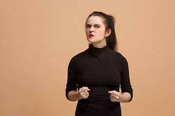 Image showing Portrait of an angry woman looking at camera isolated on a pastel background