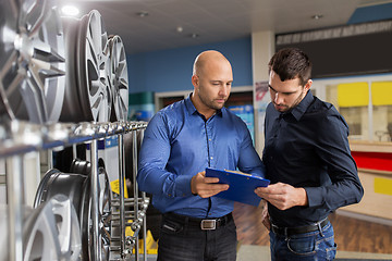 Image showing customer and salesman at car service or auto store