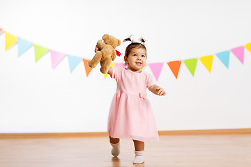 Image showing happy baby girl with teddy bear on birthday party