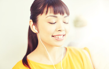 Image showing happy asian woman with earphones listening music