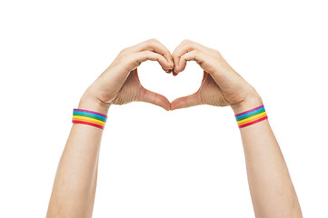 Image showing male hands with gay pride wristbands showing heart