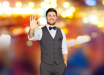 Image showing man in suit showing ok sign over night city lights