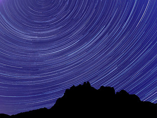 Image showing Long exposure image showing Night sky star trails over mountains