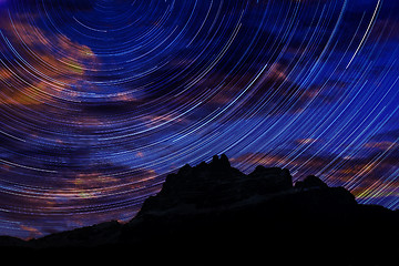 Image showing Long exposure image showing Night sky star trails over mountains