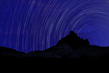 Image showing Long exposure image showing Night sky star trails over mountains