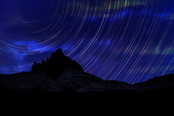 Image showing Long exposure image showing Night sky star trails over mountains