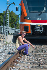 Image showing Young trendy guy in front of train
