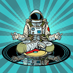 Image showing Music for meditation and yoga. Astronaut meditates