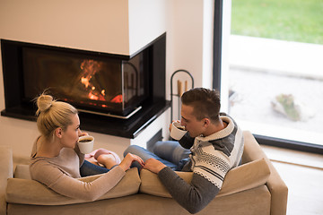 Image showing Young couple  in front of fireplace