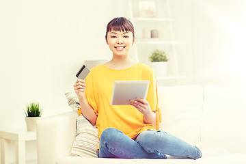 Image showing happy asian woman with tablet pc and credit card