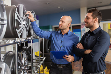 Image showing customer and salesman at car service or auto store